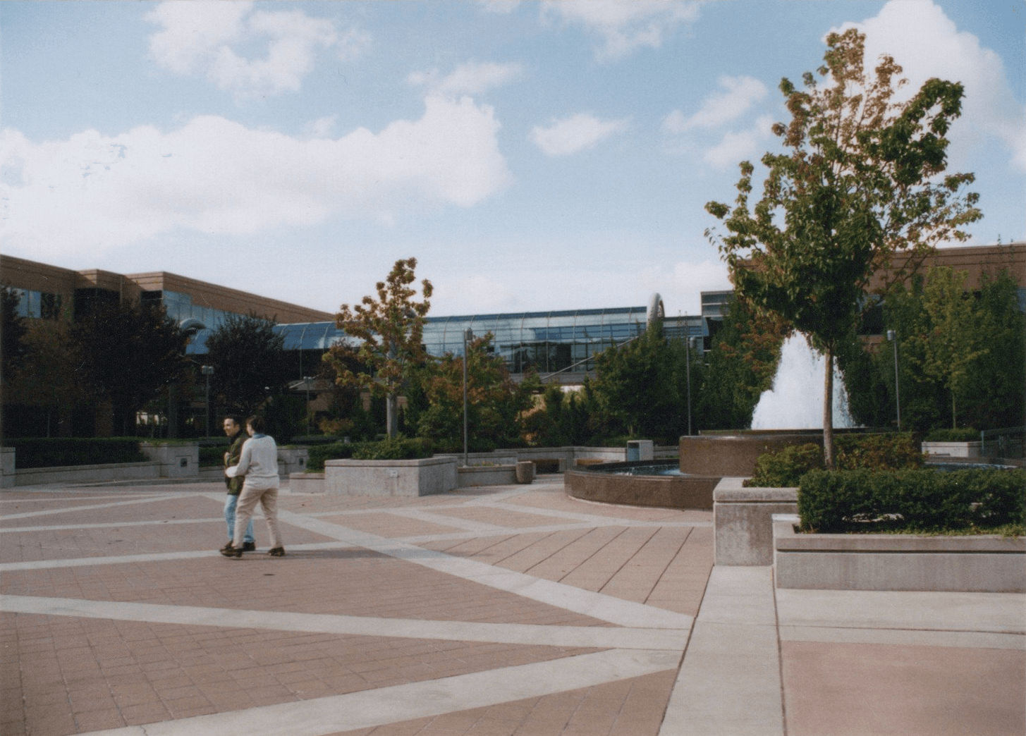 Tosh Meston and Kristen posing playfully beside a fountain in the courtyard between Microsoft Buildings 16, 17, and 18